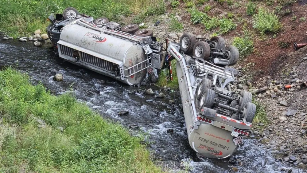 A fuel truck is seen overturned in Indian Creek in the Elwha River watershed after it crashed on Friday, July 18, 2025, near Port Angeles. (Photo courtesy of Clallam 2 Fire-Rescue)