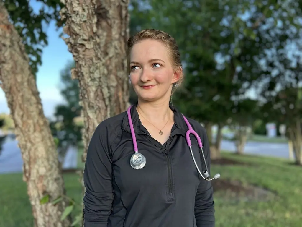 EMT Michaela Bonner stands outside a local hospital in Virginia Beach, Va. Bonner has been working 12-hour shifts for years trying to save up money to go to medical school. But now that President Donald Trump’s signature tax and spending law caps professional student loans, she’s worried her dreams of becoming a doctor are financially out of reach. (Photo by Jnaiah Price)