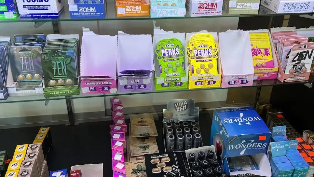 A variety of kratom and 7-OH products — including capsules, cartridges and wellness shots — are on display at a smoke shop in Buffalo, N.Y. States have led the way in regulating kratom, and now federal officials want to ban 7-OH, a powerful compound found in some kratom products. (Photo by Amanda Hernández/Stateline)