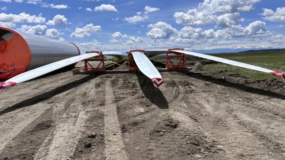 Blades of a wind turbine before they’re attached sit at a construction site in Stillwater County, Montana in May 2024. (Photo by Darrell Ehrlick of the Daily Montanan)