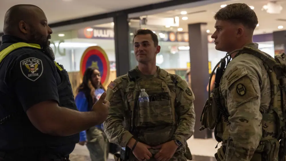 Soldiers from the South Carolina National Guard talk with an Amtrak policeman at Union Station in Washington, D.C., Aug. 20, 2025. More than 800 National Guard members from the District of Columbia, Ohio, Louisiana, Mississippi, South Carolina, and West Virginia are supporting the D.C. Safe and Beautiful Task Force. These National Guard service members provide critical support, including crowd management, presence patrols, and perimeter control, in support of law enforcement. (U.S. Army National Guard photos by Sgt. Jalen Miller)