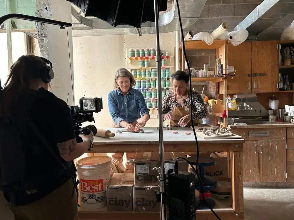 Artist Io Palmer shows me how to make clay forms in her WSU studio while director of photography Skyler Ballard films us. (Brianna Dorn/Cascade PBS)