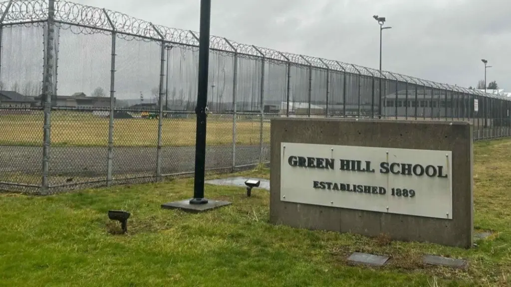 A sign and fence at the Green Hill School for juvenile offenders, in Chehalis, Washington. (Photo by Jake Goldstein-Street/Washington State Standard)
