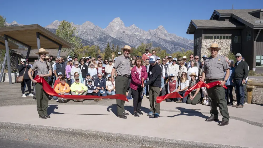 Joined by a crowd of community members, Chip Jenkins, Superintended of Grand Teton National Park, Leslie Mattson, President of Grand Teton National Park Foundation and Chuck Fleischman, Project Committee Chair, cut a ceremonial ribbon. NPS Photo/M. Nall