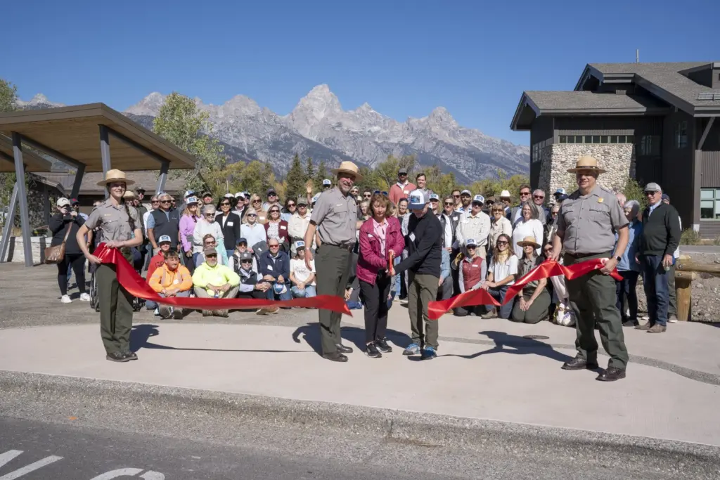 Joined by a crowd of community members, Chip Jenkins, Superintended of Grand Teton National Park, Leslie Mattson, President of Grand Teton National Park Foundation and Chuck Fleischman, Project Committee Chair, cut a ceremonial ribbon. NPS Photo/M. Nall