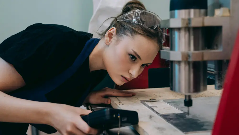 Photo by Mikhail Nilov: https://www.pexels.com/photo/a-woman-watching-a-cutter-machine-9241704/