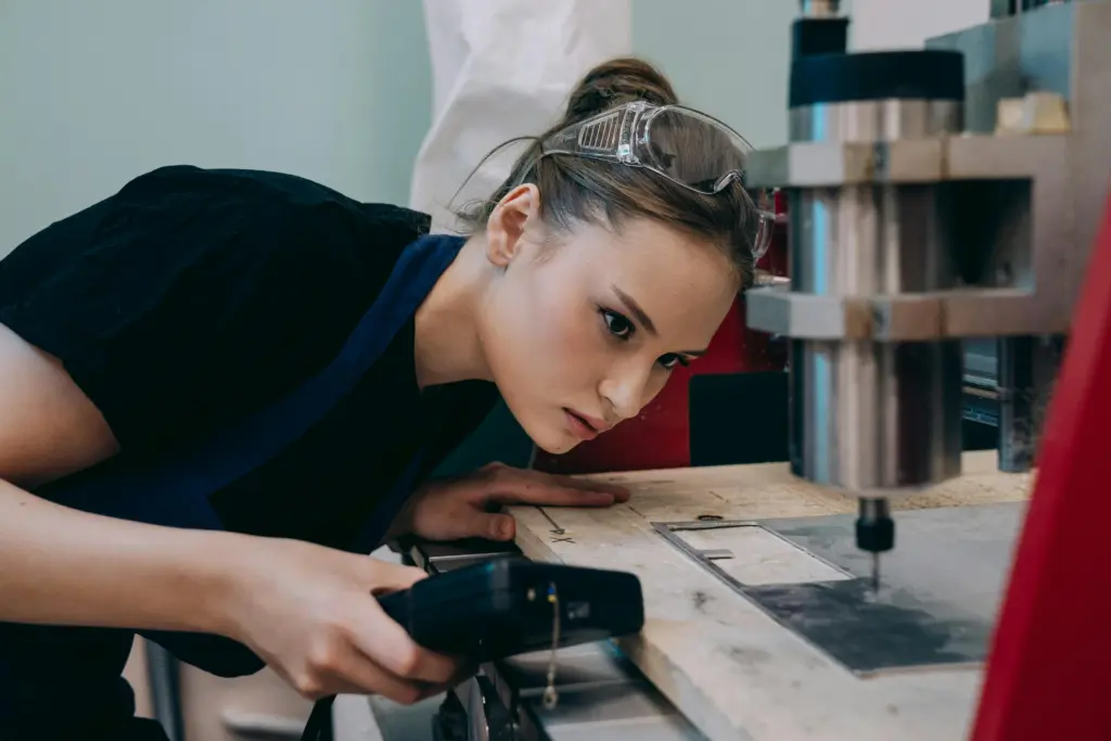 Photo by Mikhail Nilov: https://www.pexels.com/photo/a-woman-watching-a-cutter-machine-9241704/