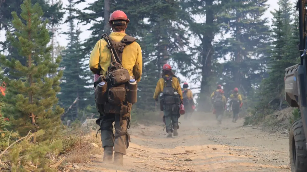 Photo Credit: NW2 PIO Ranger Peelee contributed this image of Montana’s Bitterroot Hotshots hiking along the fireline during the Lower Sugarloaf Fire 2025.
