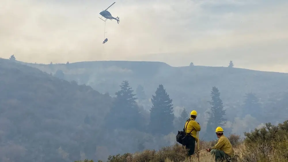 Two firefighters monitor fire behavior as a helitorch lights the interior of a prescribed fire burn unit during the 2019 Yellowjacket Prescribed Burn on the Minidoka Ranger District of the Sawtooth National Forest. (Photo courtesy of U.S. Forest Service)