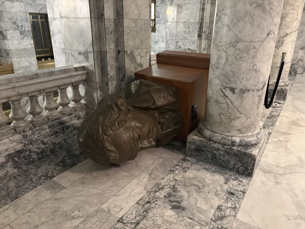 A bronze bust of George Washington lies on its side inside the Washington State Legislative Building following an act of vandalism on October 5, 2025. Photo Credit: Washington State Department of Enterprise Services
