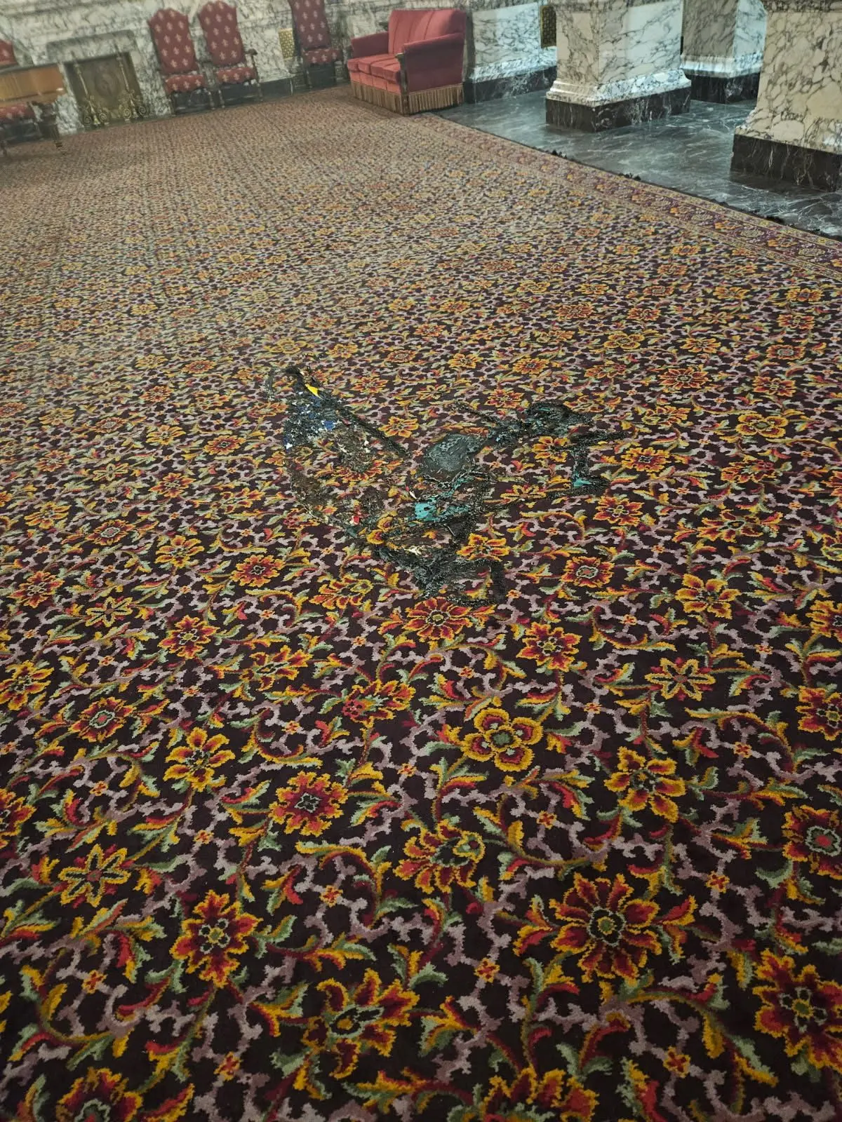 Charred areas on the carpet of the State Reception Room show the aftermath of fire damage caused during the Capitol vandalism. Photo Credit: Washington State Department of Enterprise Services