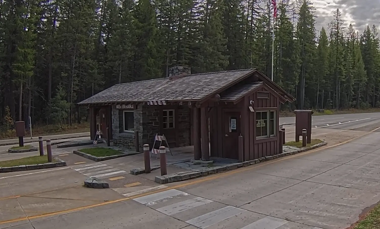A webcam image of the entrance station to Glacier National Park shows blocked off lanes and shuttered windows on Oct. 3, 2025.