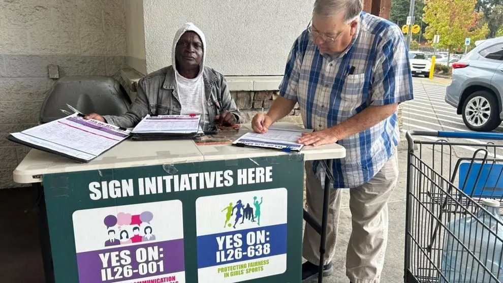 Oct 1, 2025 signature gatherer outside Federal Way, Wash. Walmart as dozens of attacks are reported on initiative workers. Photo by Carleen Johnson