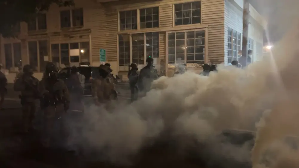 Federal officers spray and throw chemical gases at demonstrators a block up from the ICE processing facility south of downtown Portland on Saturday, Oct. 5, 2025. (Photo by Alex Baumhardt/Oregon Capital Chronicle)