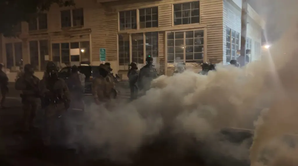 Federal officers spray and throw chemical gases at demonstrators a block up from the ICE processing facility south of downtown Portland on Saturday, Oct. 5, 2025. (Photo by Alex Baumhardt/Oregon Capital Chronicle)