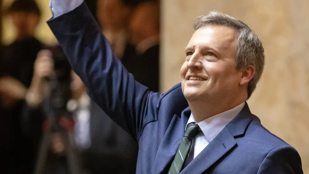 Washington state Commissioner of Public Lands Dave Upthegrove waves to the crowd during inauguration ceremonies at the Washington state Capitol, in Olympia, on Jan. 15, 2025. (Photo by Ryan Berry/Washington State Standard)
