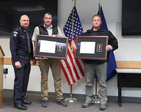 Idaho State Police detective Chris Pohanka, pictured on the right in this handout photo from Jan. 30, 2025, receives a commendation for helping to prevent a highway accident months earlier. Pohanka worked on the team of detectives that routinely handled reports of sexual abuse by staff at Idaho state prisons. (Idaho State Police handout)