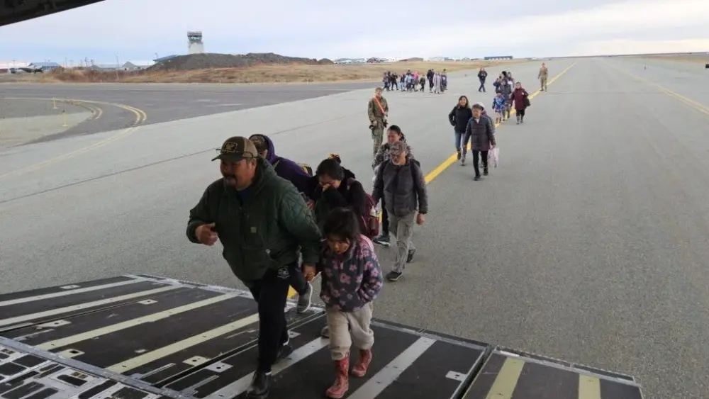 Evacuees board a C-17 military transport plane from Bethel to Anchorage on Oct. 16, 2025 (Photo by Corinne Smith/Alaska Beacon)