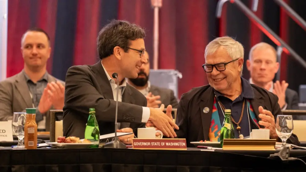 Washington Gov. Bob Ferguson, left, shakes hands with Cowlitz Indian Tribe Chairman Bill Iyall after signing an executive order to improve the state’s relations with tribal governments on Oct. 22, 2025. (Photo courtesy of Washington governor’s office)