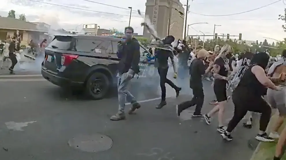 A protester throws a smoke canister back toward Spokane police officers and sheriff’s deputies during a demonstration. Courtesy of a contributor to The Center Square
