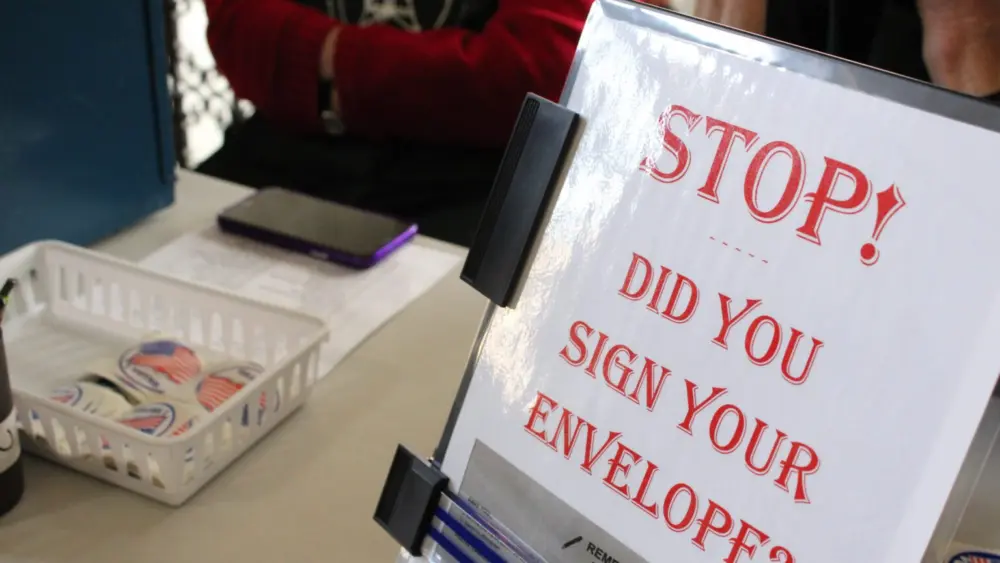 A new law in effect this year requires voters to sign their. ballot envelope AND write their birth year. (Photo by Blair Miller, Daily Montanan)