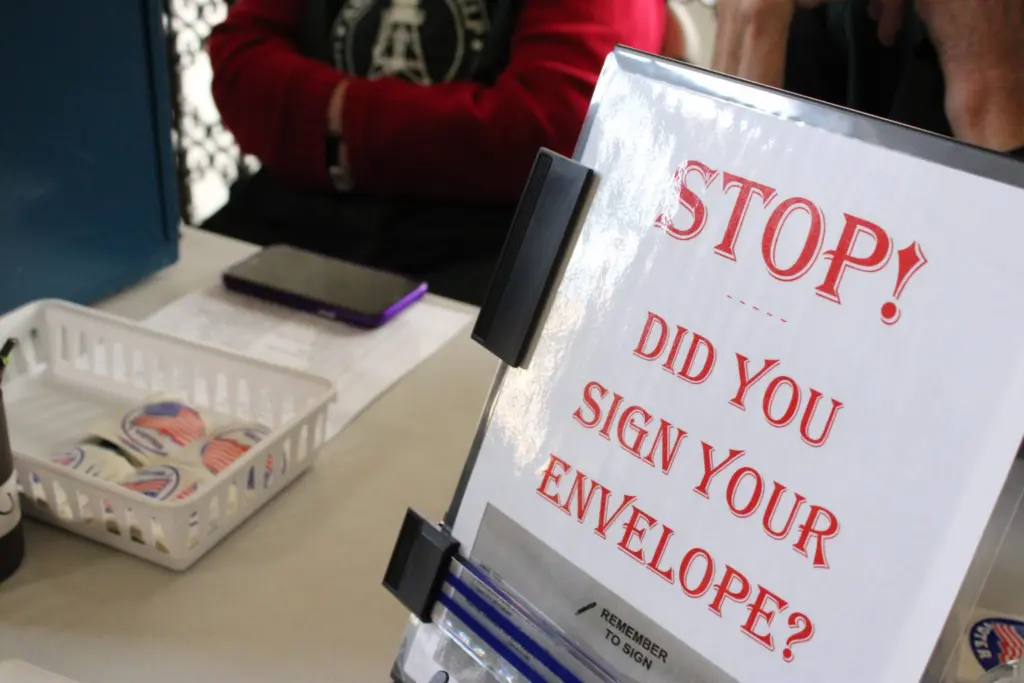 A new law in effect this year requires voters to sign their. ballot envelope AND write their birth year. (Photo by Blair Miller, Daily Montanan)