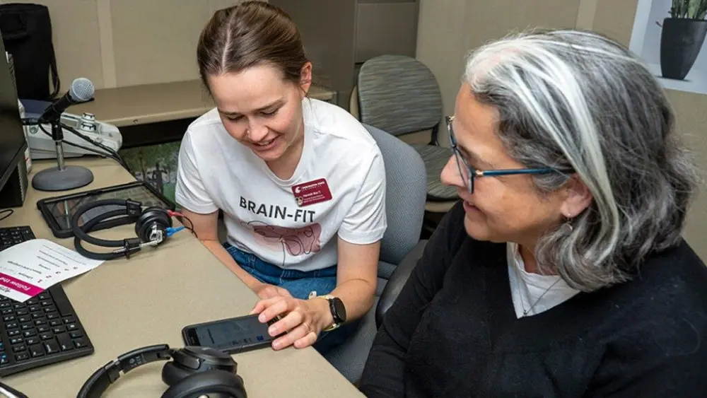 Graduate student Hannah Tjelle with a BRAIN FIT participant (photo courtesy of Cori Kogan, WSU).