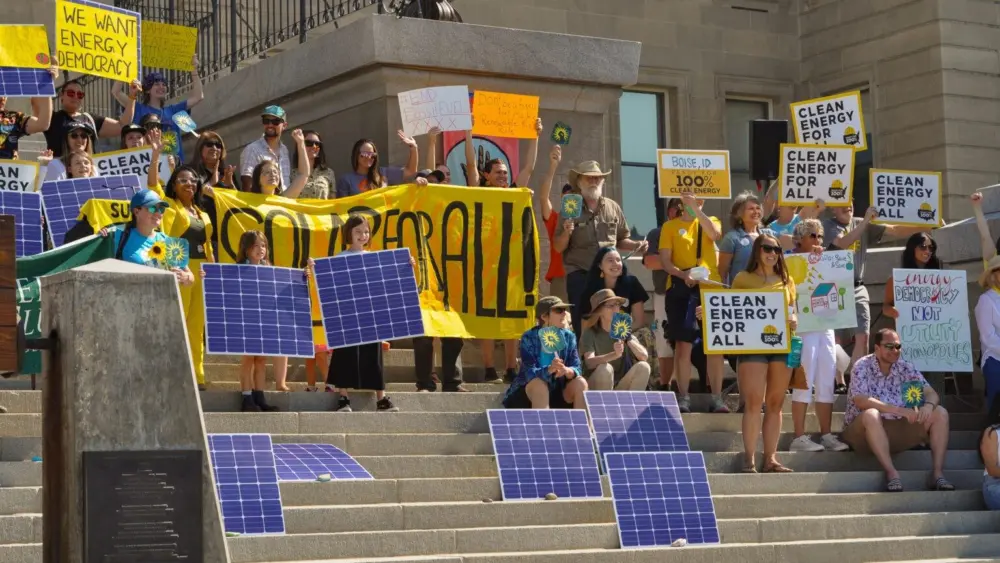 Idahoans hold up signs supporting solar energy at the Idaho State Capitol in Boise in 2024. (Courtesy of the Idaho Chapter Sierra Club)