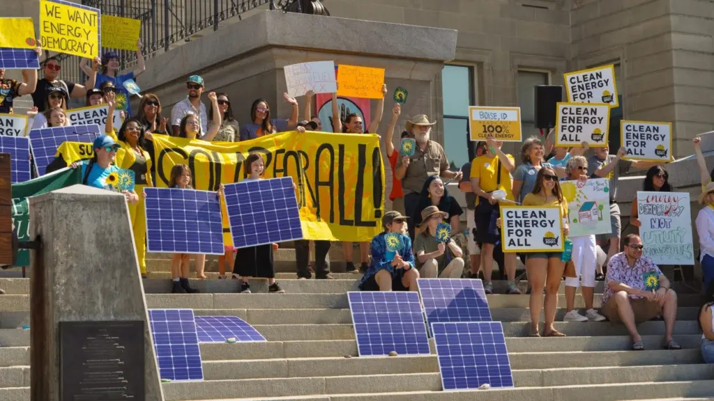 Idahoans hold up signs supporting solar energy at the Idaho State Capitol in Boise in 2024. (Courtesy of the Idaho Chapter Sierra Club)