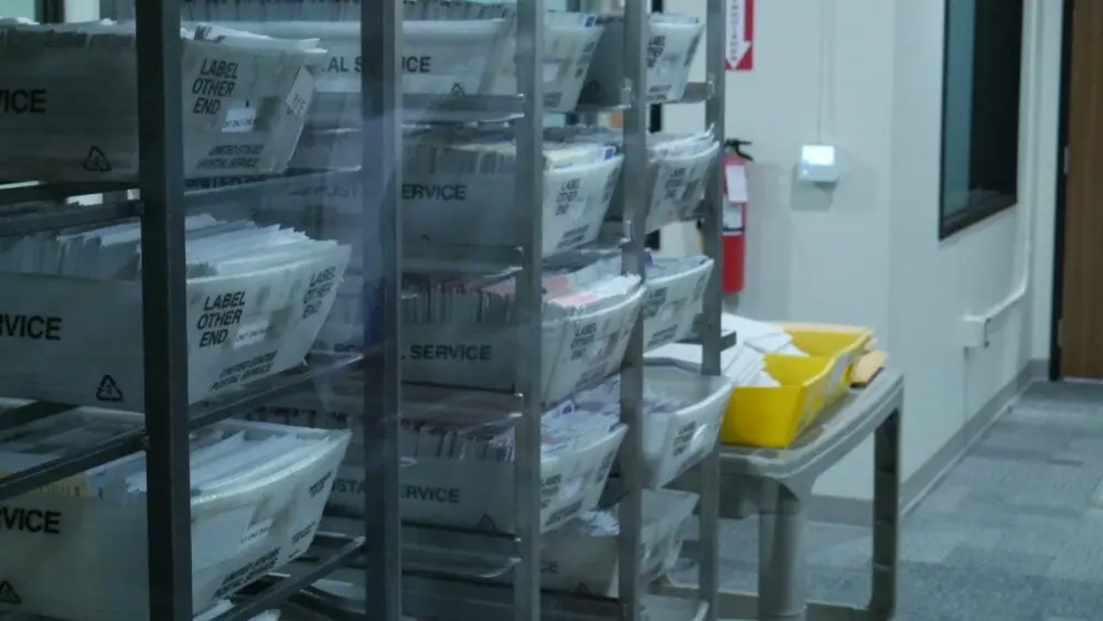 Baskets of ballots sit at Thurston County’s new ballot processing center on Thursday. (Photo by Jake Goldstein-Street/Washington State Standard)