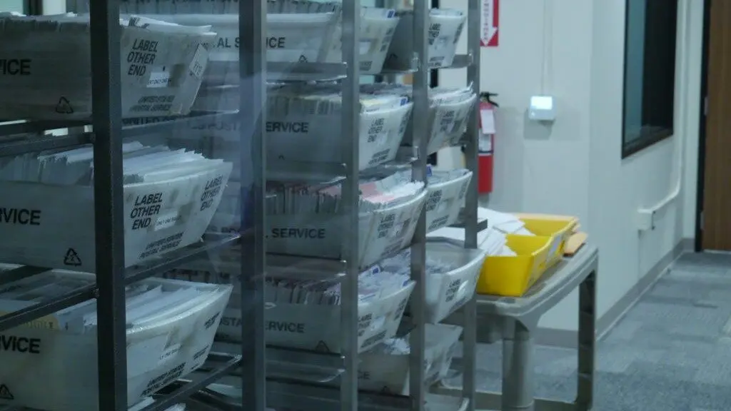 Baskets of ballots sit at Thurston County’s new ballot processing center on Thursday. (Photo by Jake Goldstein-Street/Washington State Standard)