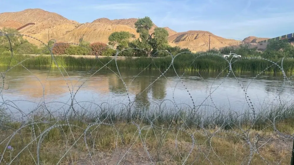 Razor wire follows the banks of the Rio Grande on the Texas side of the U.S.-Mexico border in 2024. The Trump administration now expects about 600,000 total deportations in 2025, fewer than the 685,000 under the Biden administration in fiscal 2024. (Photo by Ariana Figueroa/States Newsroom)