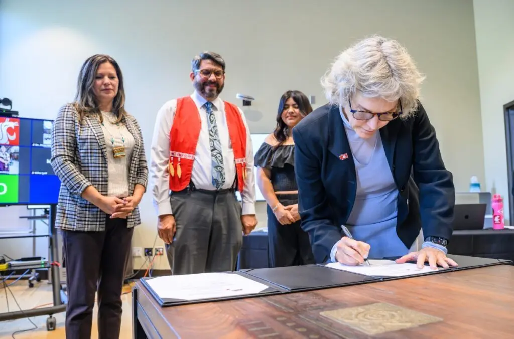 WSU President Elizabeth Cantwell signing the university’s memorandum of understanding as part of a new symbolic partnership with the Upper Skagit Indian Tribe (photo by Robert Hubner, WSU Photo Services).