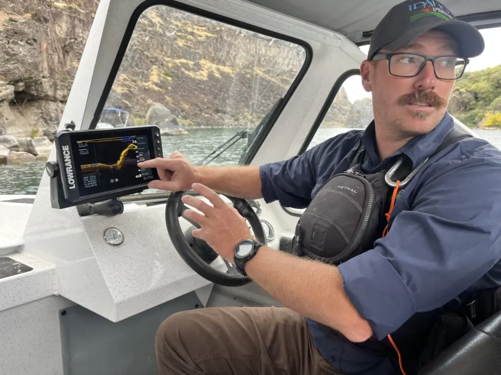 Jeremey Varley, the Idaho State Department of Agriculture’s southern chief treatment engineer, explains the state’s strategy for eradicating invasive quagga mussels during a boat tour of the infested portion of the Snake River on Oct. 3. (Photo by Clark Corbin/Idaho Capital Sun)