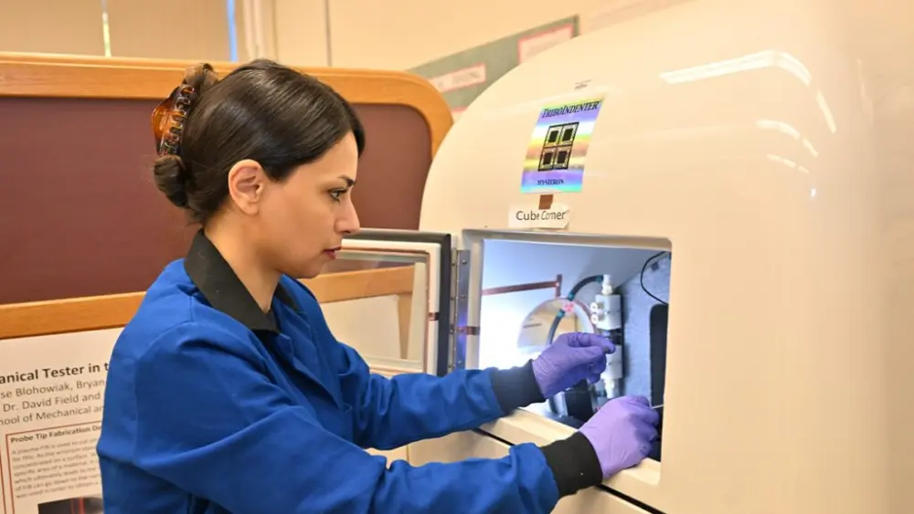 Assistant Professor Arezoo Zare loads a sample into a nano-indenter to evaluate localized mechanical properties (photo by WSU Photo Services).