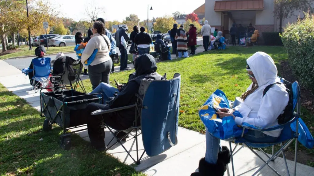 Furloughed federal workers stand in line for hours ahead of a special food distribution by the Capital Area Food Bank and No Limits Outreach Ministries on Barlowe Road in Hyattsville, Maryland, on Tuesday, Oct. 28, 2025. (Photo by Ashley Murray/States Newsroom)