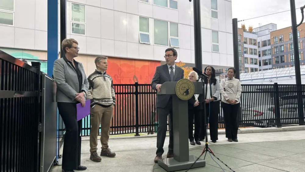 Washington Gov. Bob Ferguson speaks to Andi Smith of the Ballmer Group after the announcement of a major new philanthropic donation to fund early childhood education on Wednesday, Nov. 12, 2025, at the Denise Louie Education Center in Seattle, Washington. (Photo by Jake Goldstein-Street/Washington State Standard)
