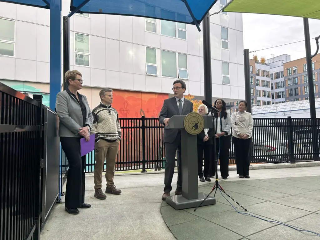 Washington Gov. Bob Ferguson speaks to Andi Smith of the Ballmer Group after the announcement of a major new philanthropic donation to fund early childhood education on Wednesday, Nov. 12, 2025, at the Denise Louie Education Center in Seattle, Washington. (Photo by Jake Goldstein-Street/Washington State Standard)