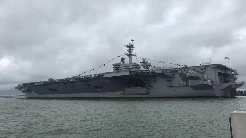 The USS Abraham Lincoln sits in the water with flags displayed above the deck. Photo: Sarah Roderick-Fitch / The Center Square