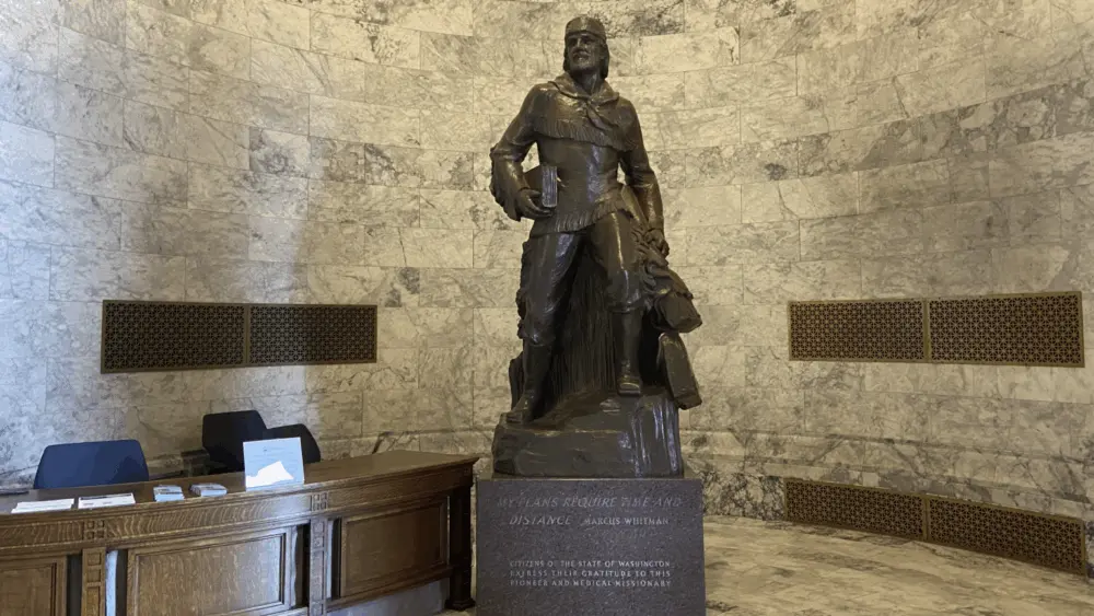 A bronze Marcus Whitman statue in the Washington state Capitol building weighs over 9,000 pounds with its stone base. (Jacquelyn Jimenez Romero/Washington State Standard)