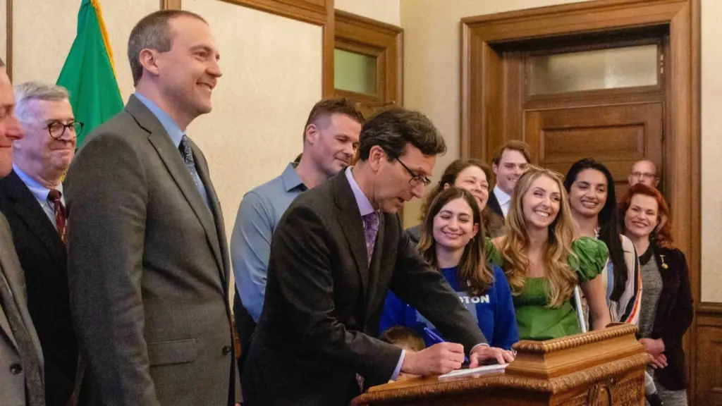 Gov. Bob Ferguson signing Senate Bill 5480, a bill exempting medical debt from credit reports, on April 22, 2025. (Photo by Jacquelyn Jimenez Romero/Washington State Standard)