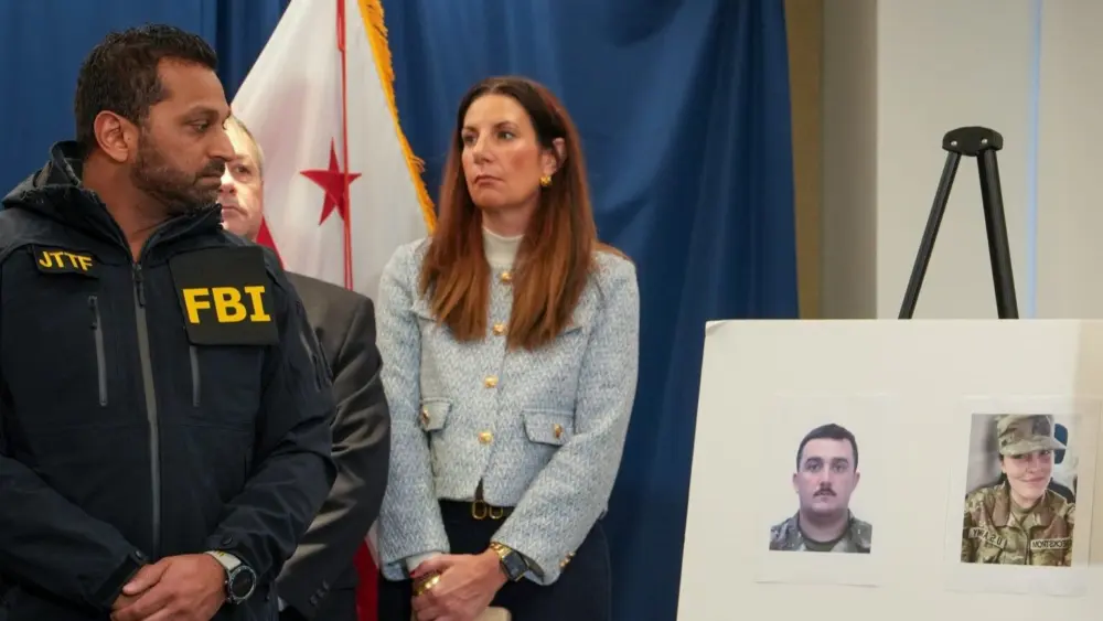 FBI Director Kash Patel, left, at a press conference on Nov. 27, 2025, looks at photos of the two West Virginia National Guard soldiers shot in Washington, D.C., the previous day. They were identified as Andrew Wolfe, 24, and Sarah Beckstrom, 20. (Photo by Andrew Leyden/Getty Images)