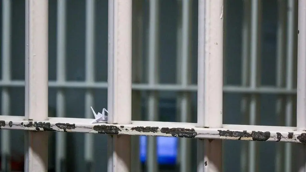 A paper crane sits on the bars inside Spokane County’s downtown jail. Photo: Tim Clouser / The Center Square