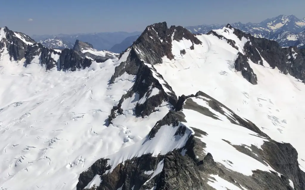 he Boston Glacier, left, viewed from Forbidden Peak, falls away from Boston Peak in the North Cascades. Boston Basin to the right. (Bill Lucia/Washington State Standard)