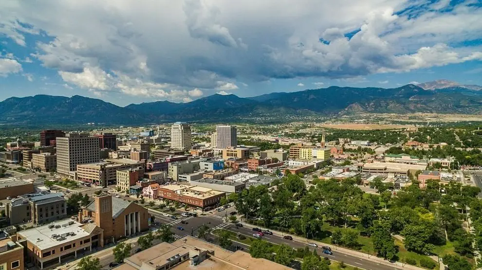 An aerial view shows downtown Colorado Springs, Colorado, with Pikes Peak in the distance. Photo: Kevin Bree / Unsplash