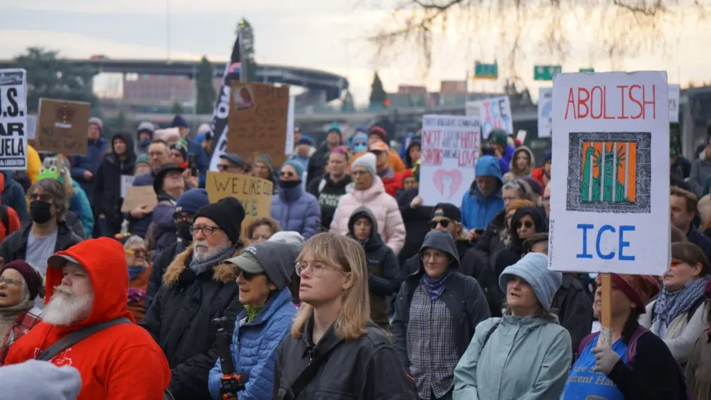 More than 200 people attended a protest on Jan. 10, 2025 in Portland at the Willamette River waterfront against Immigration and Customs Enforcement and U.S. military attacks on Venezuela. (Photo by Alex Baumhardt/Oregon Capital Chronicle)