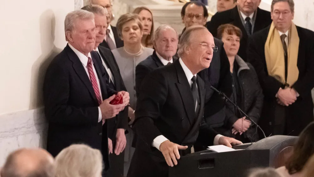 Former Idaho Gov. Dirk Kempthorne, who also served as the U.S. Secretary of the interior from 2006 to 2009 during the George W. Bush administration, speaks at the service for Phil Batt at the Idaho Capitol on March 9, 2023. Behind him, right to left, are former Idaho governor and and current U.S. Sen. Jim Risch, current Gov. Brad Little, and former Gov. C. L. “Butch” Otter. (Otto Kitsinger for Idaho Capital Sun)