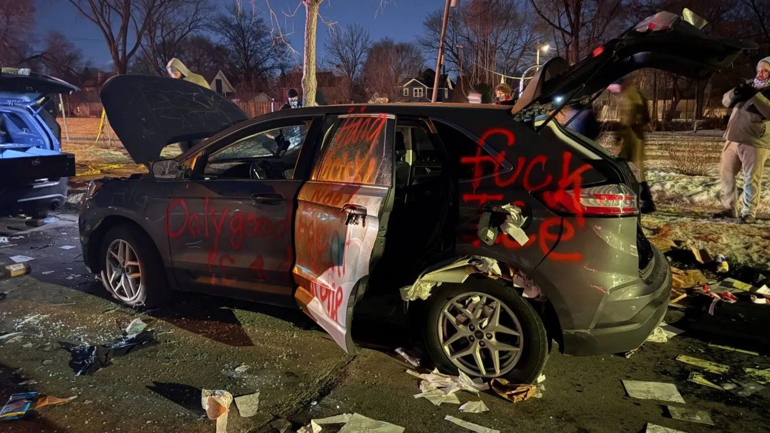 Anti-ICE demonstrators vandalized a vehicle in Minneapolis believed to be used by federal agents, in the aftermath of a shooting by a federal officer, the second in a week, Jan. 14, 2026. (Photo by Max Nesterak/Minnesota Reformer)