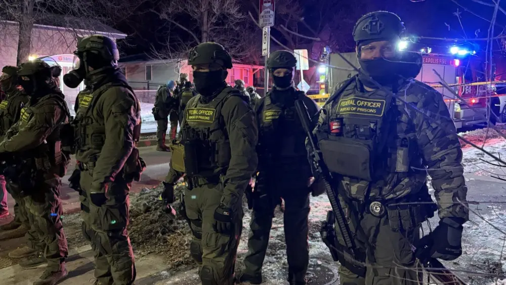 Federal Bureau of Prisons officers on the scene where a federal immigration agent shot a man Wednesday, Jan. 14, 2026, in north Minneapolis. (Photo by Max Nesterak/MInnesota Reformer)