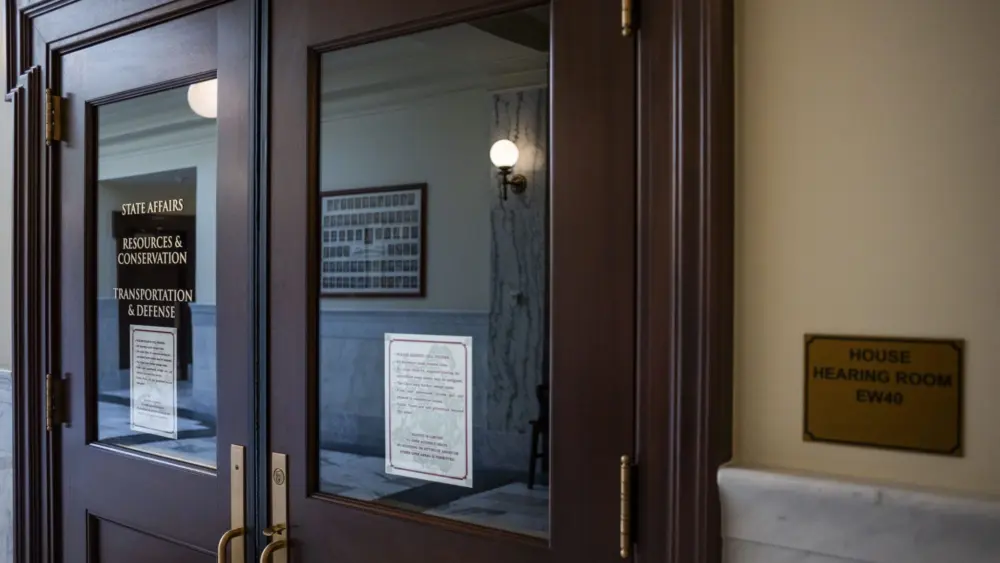 The door to the meeting room for the House’s State Affairs, Resources and Conservation, and Transportation and Defense committees as seen on March 10, 2025, at the Idaho Capitol Building in Boise. (Pat Sutphin for the Idaho Capital Sun)